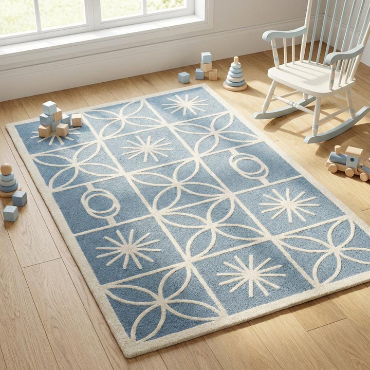 Translation missing: en.Soft blue geometric nursery rug styled in kids room, featuring plush cream starburst design ideal for play area and cozy family-friendly space