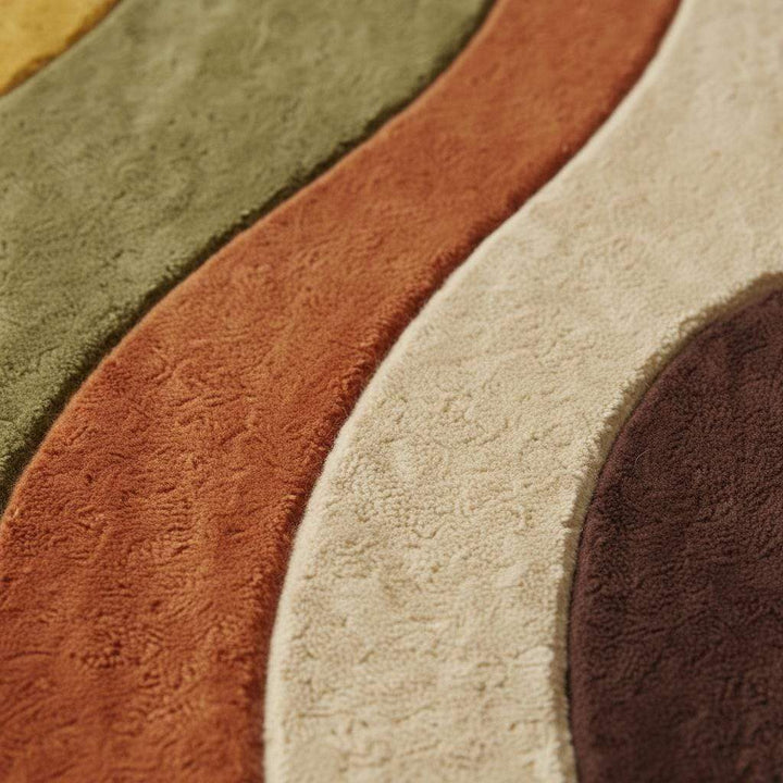 Translation missing: en.Earth tone abstract area rug with curved wavy shapes in mustard, olive and rust, styled in a sunny mid century living room with wood parquet floor and yellow chair