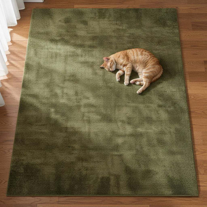 Translation missing: en.Modern living room décor featuring an olive green area rug, light wood floor, neutral walls and a potted plant – stylish home carpet