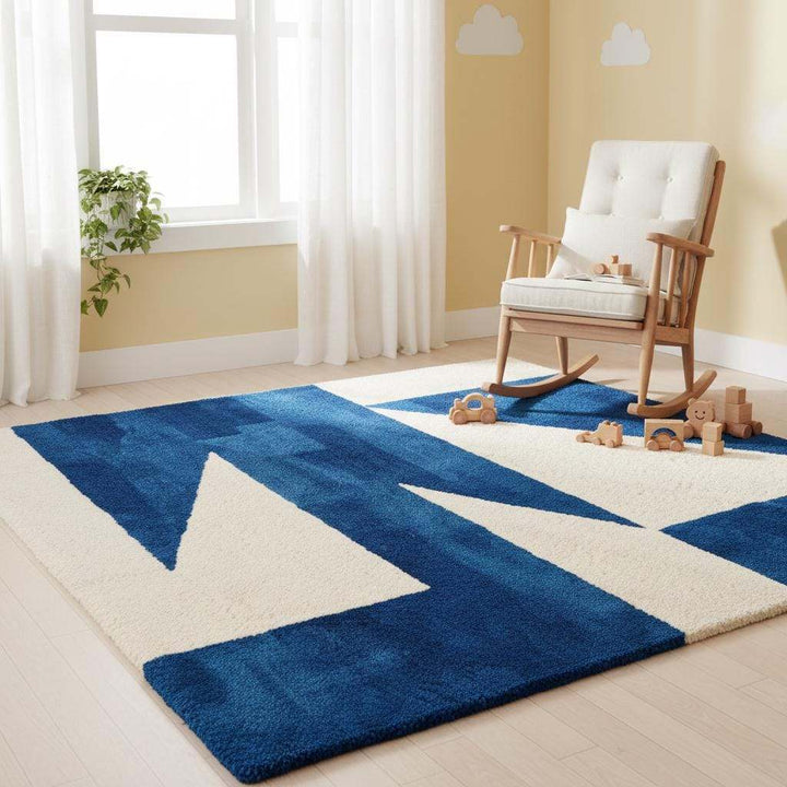 Translation missing: en.Soft hand-tufted geometric area rug in deep blue and ivory tones, enhancing a cozy contemporary living room