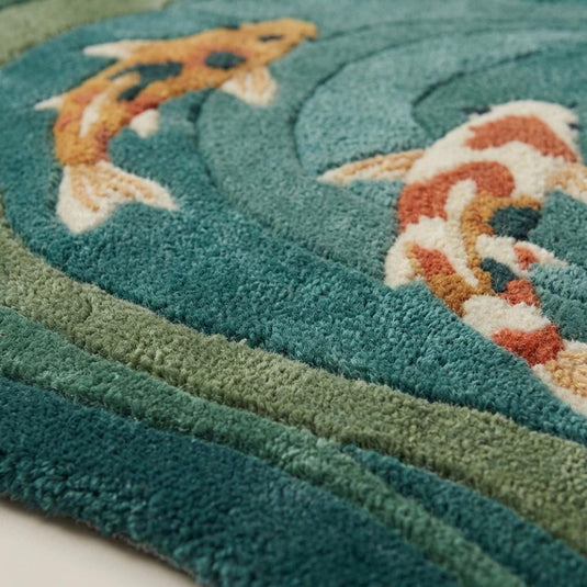 Translation missing: es.Close-up of dense wool hand-tufted pile showing sculpted carved texture and soft fiber surface in teal and sage tones