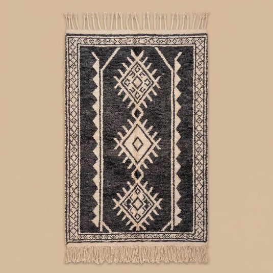 Translation missing: es.Full view of black and ivory tribal Moroccan rug with decorative fringe