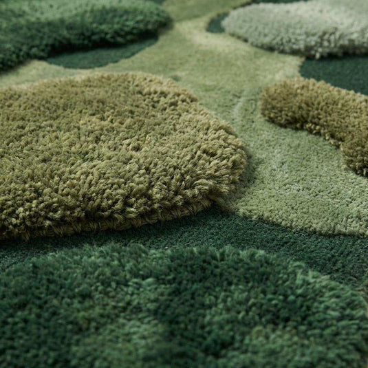 Translation missing: en.Close up of hand tufted wool moss rug showing high low sculpted pile texture