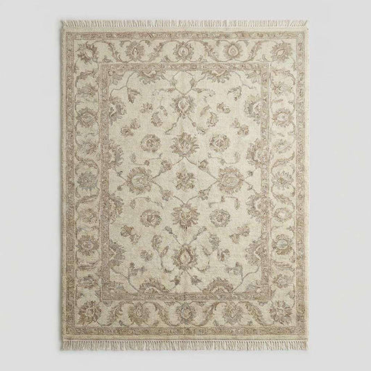 Translation missing: es.Ivory and beige wool Oushak rug with subtle floral motifs and traditional border design