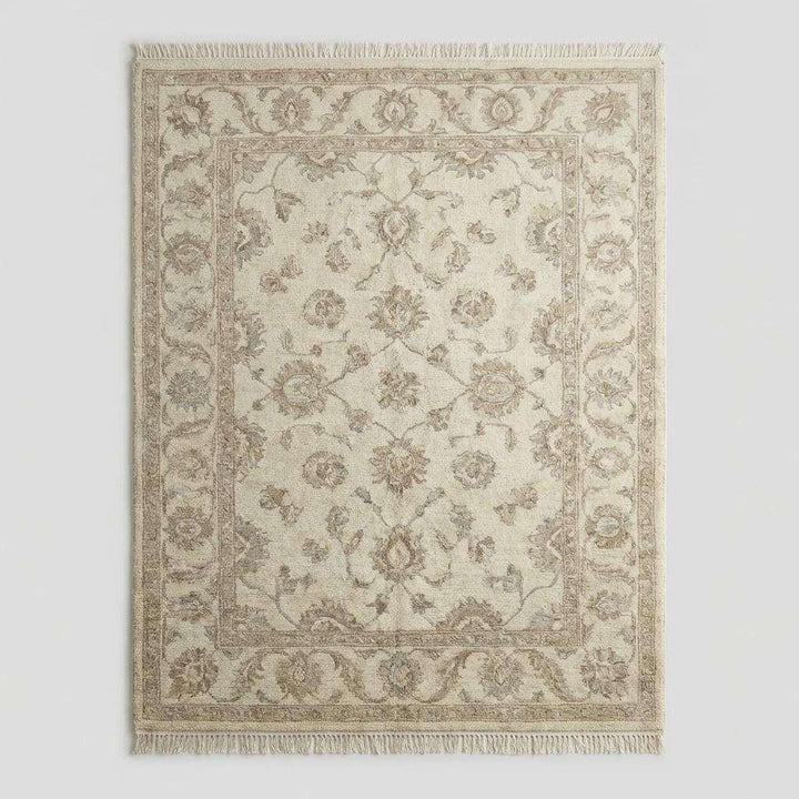 Translation missing: es.Ivory and beige wool Oushak rug with subtle floral motifs and traditional border design