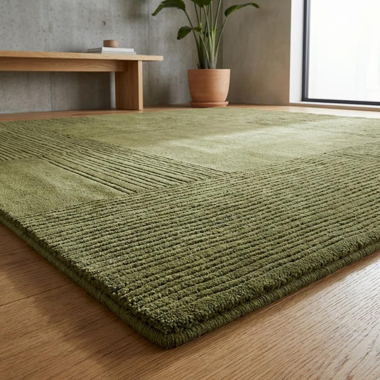 Translation missing: es.Close up of olive green textured area rug showing ribbed linear pattern and soft plush fibers in geometric square design