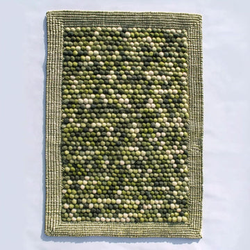 Translation missing: fr.Handmade olive green felt ball rug with chunky wool texture for boho and Scandinavian home décor