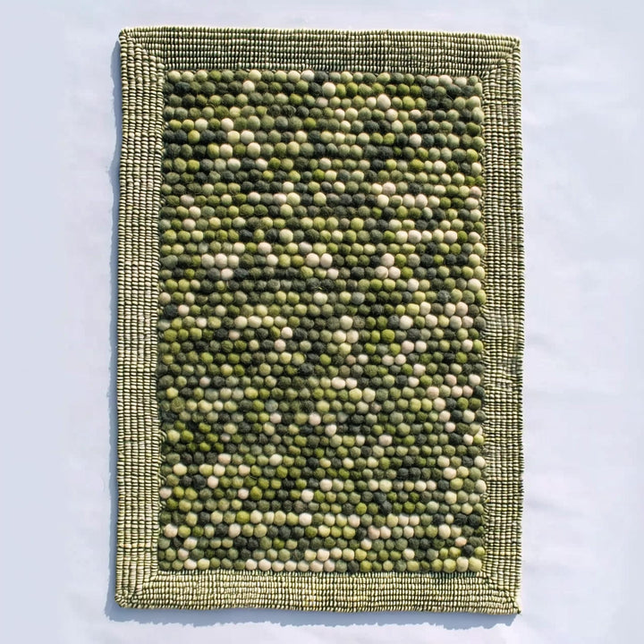 Translation missing: es.Handmade olive green felt ball rug with chunky wool texture for boho and Scandinavian home décor