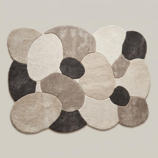 Translation missing: es.Abstract pebble inspired modern area rug with layered organic forms placed beneath accent chair in cozy interior __etsy:8074281827