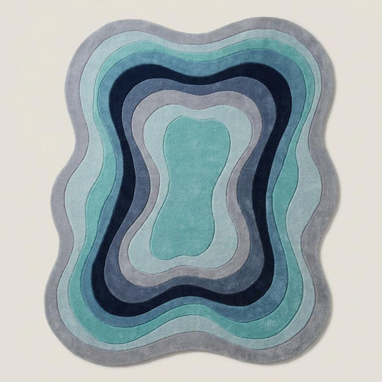 Translation missing: es.Contemporary irregular area rug in layered blue and teal shades placed beside a mid century modern accent chair __etsy:8006148360