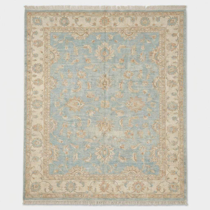 Translation missing: es.Artisan hand knotted wool rug styled in living room with hardwood flooring