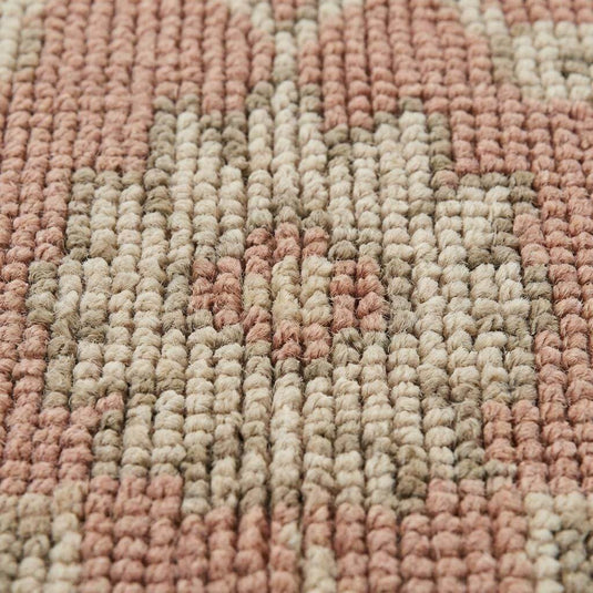 Translation missing: en.Close up of hand knotted wool rug showing low pile texture, visible knot structure, and natural color variation