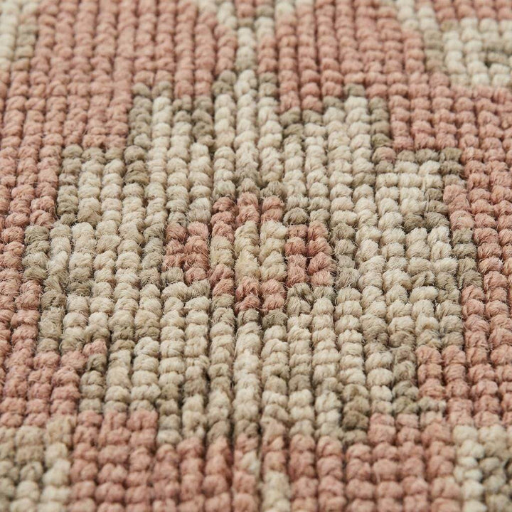 Translation missing: en.Close up of hand knotted wool rug showing low pile texture, visible knot structure, and natural color variation