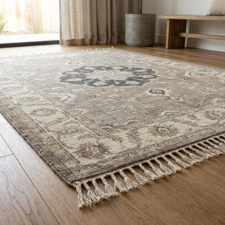 Translation missing: es.Artisan made Oushak style wool rug featuring central medallion and muted neutral tones