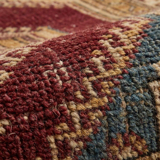 Translation missing: en.Close-up of hand knotted wool pile showing dense knot structure, natural fiber texture, and artisan craftsmanship