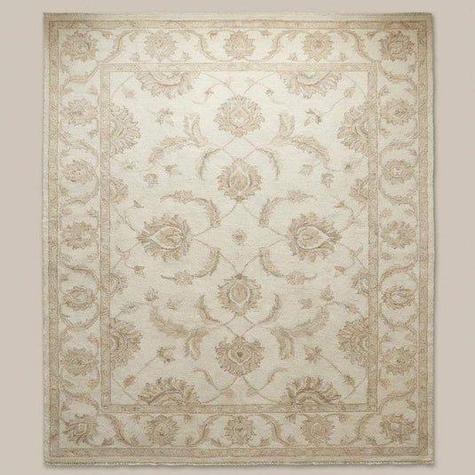 Translation missing: en.Neutral floral wool rug styled in bright living room with wooden flooring