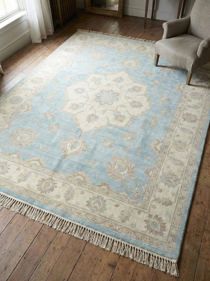 Translation missing: en.Hand knotted Oushak wool area rug in soft blue with traditional floral medallion design