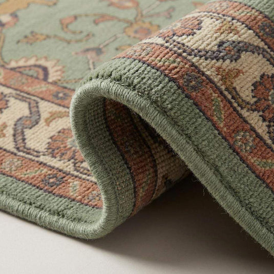 Translation missing: es.Close up of hand knotted wool rug showing dense knot structure, cut pile texture, cotton foundation, fine artisan craftsmanship detail