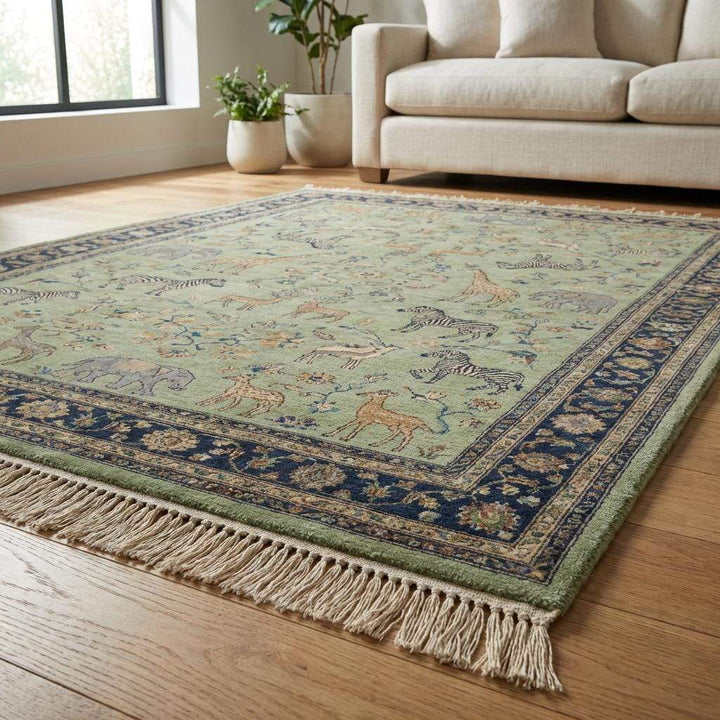 Translation missing: es.Wool area rug featuring zebra giraffe and elephant motifs in sage green field
