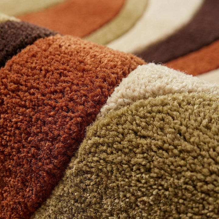 Translation missing: en.Close up of dense hand tufted wool pile showing plush carved wave texture and soft cut fiber surface