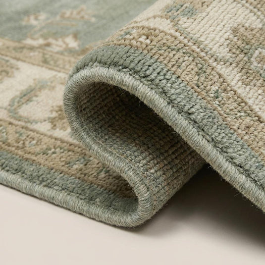 Translation missing: fr.Close-up of hand knotted wool rug showing individual knots, soft natural wool fibers, and slightly textured pile surface