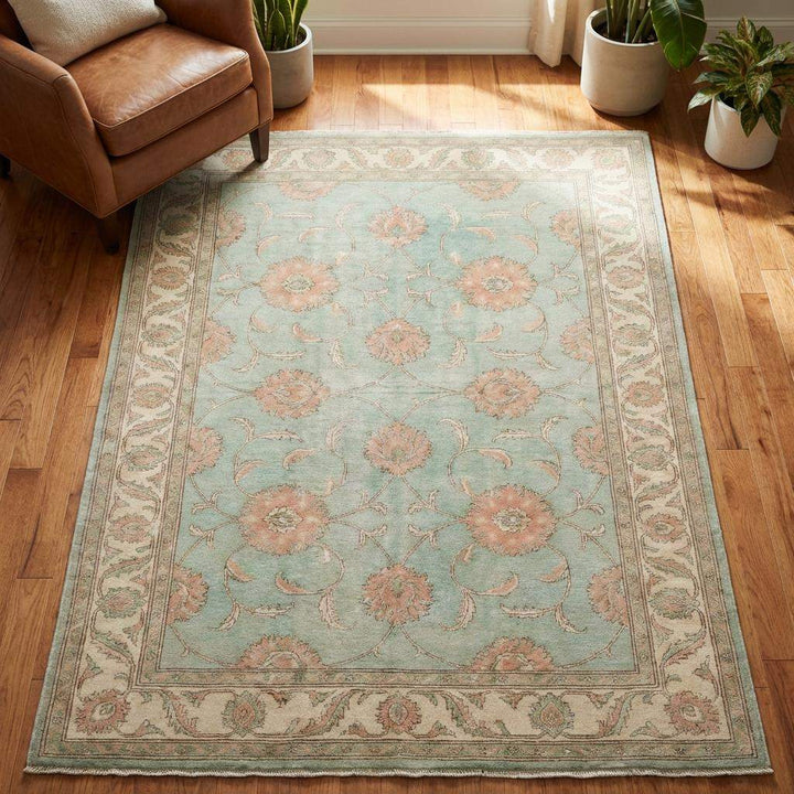 Translation missing: en.Elegant sage green floral area rug styled for living room décor, showcasing handmade craftsmanship and balanced pattern layout