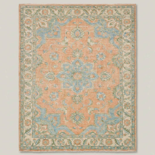 Translation missing: en.Traditional Oushak wool rug styled in bright living room with wooden floors