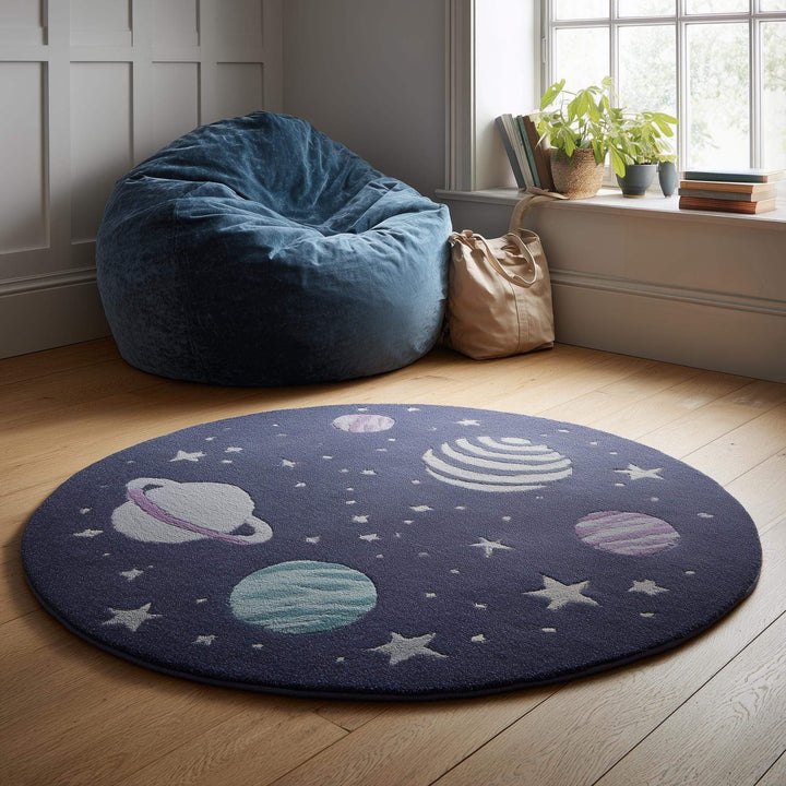 Translation missing: es.Space theme round rug with astronaut and planet design in navy wool nursery decor