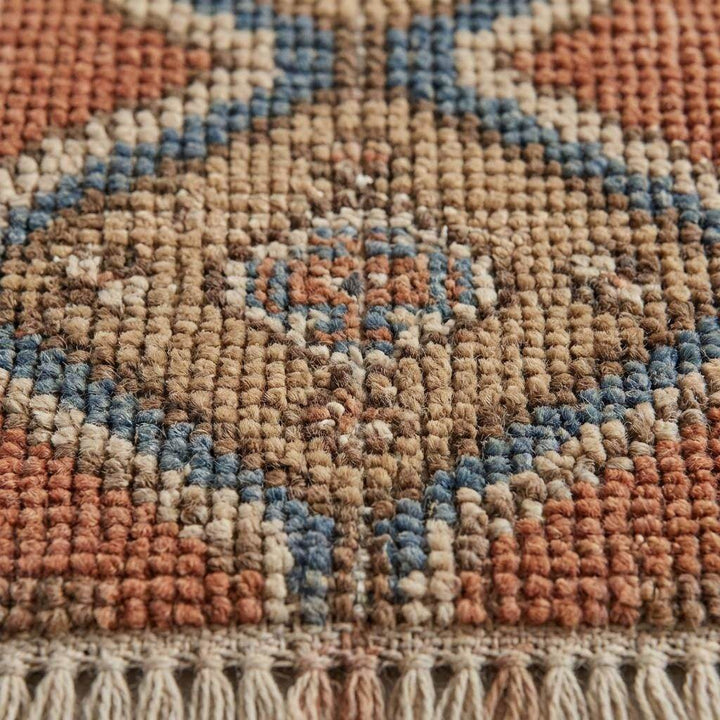 Translation missing: en.Close-up of hand knotted wool pile showing individual knot structure and natural fiber texture