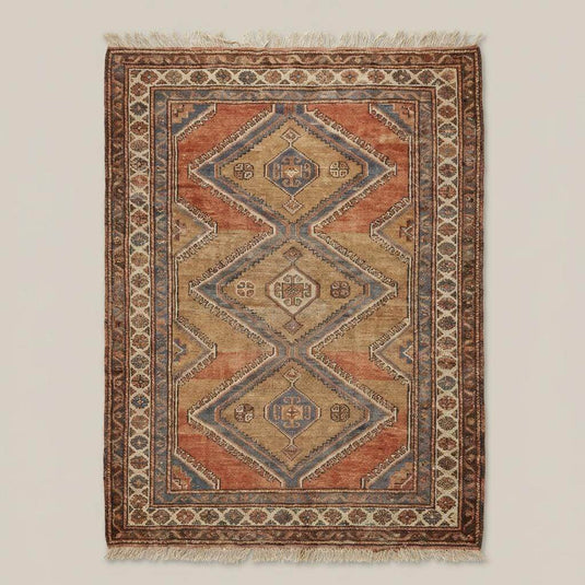 Translation missing: es.Rust and beige tribal geometric hand knotted rug styled in living room