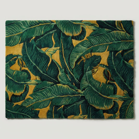 Translation missing: es.Top-down view of green and mustard botanical area rug displaying oversized tropical leaf pattern, full-coverage design, sculpted texture, and modern jungle-inspired aesthetic