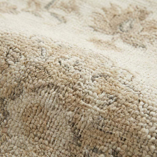 Translation missing: es.Close up of hand knotted wool rug showing low pile texture, individual knots, and natural wool fibers