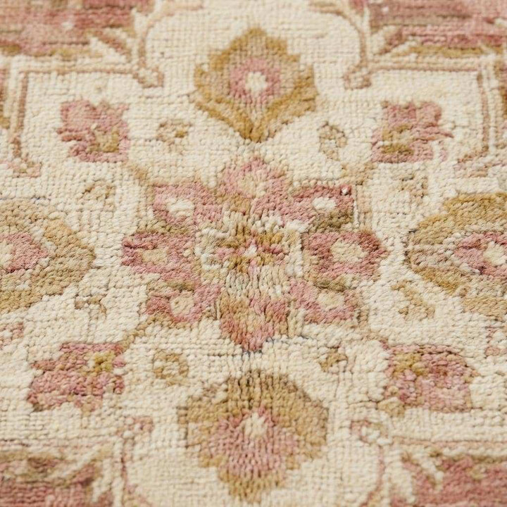 Translation missing: en.Close-up of hand knotted wool pile showing low pile texture, natural fibers, and subtle abrash variations