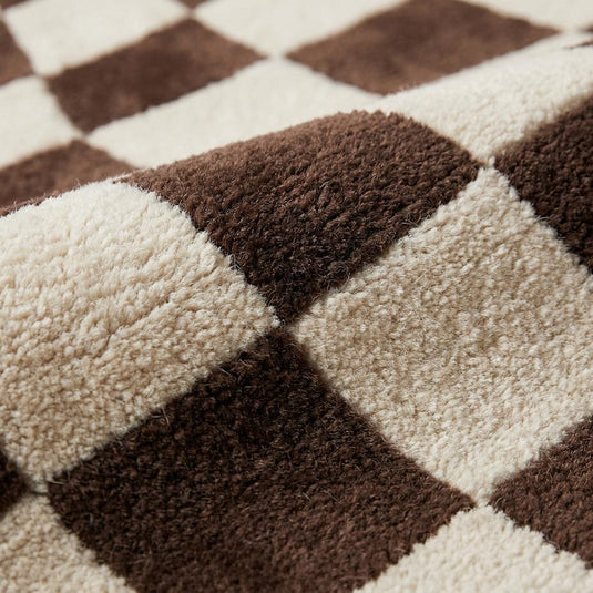 Translation missing: es.Close-up texture of plush hand-tufted wool rug showing soft cut pile and sculpted checkerboard pattern in brown and cream __etsy:8074304171