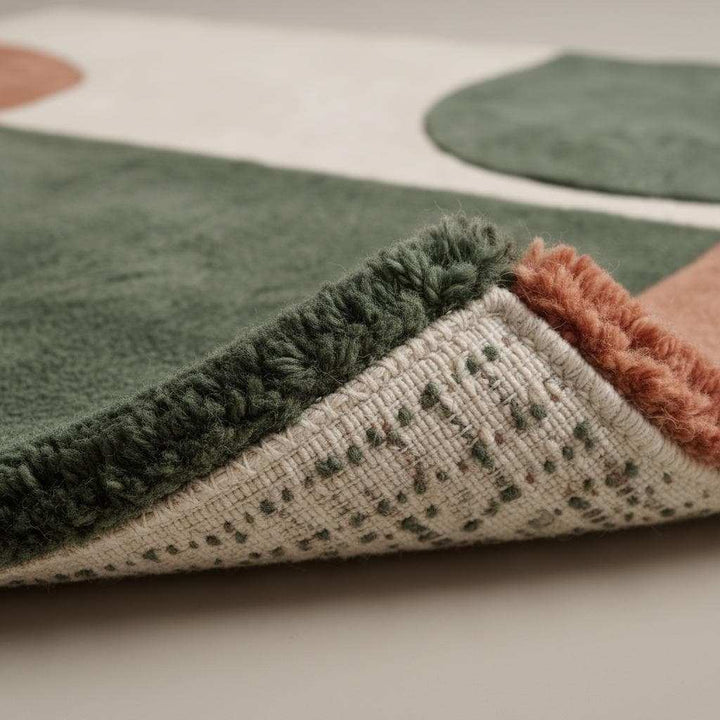 Translation missing: en.Modern geometric wool rug with terracotta, green, and cream abstract design and plush tufted texture
