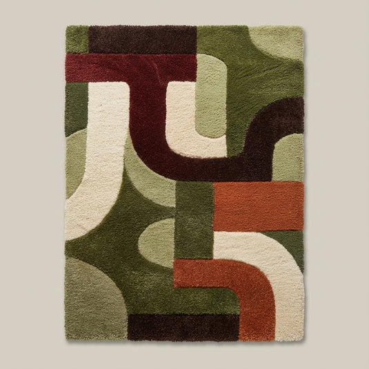 Translation missing: es.Earth tone geometric shag area rug featuring rust, green, cream, and brown shapes in a modern living room with indoor plants and wood paneling