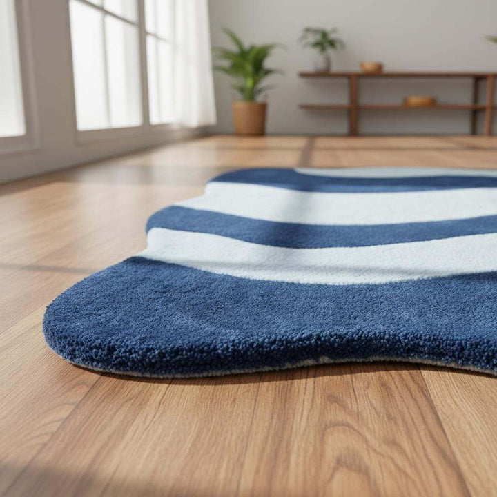 Translation missing: en.Large modern curved rug with organic wave design placed in stylish living room with wooden furniture and greenery
