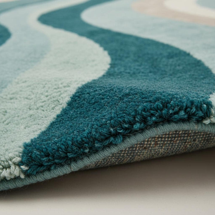 Translation missing: en.Close-up detail of a handmade tufted rug showing textured wool and stitching