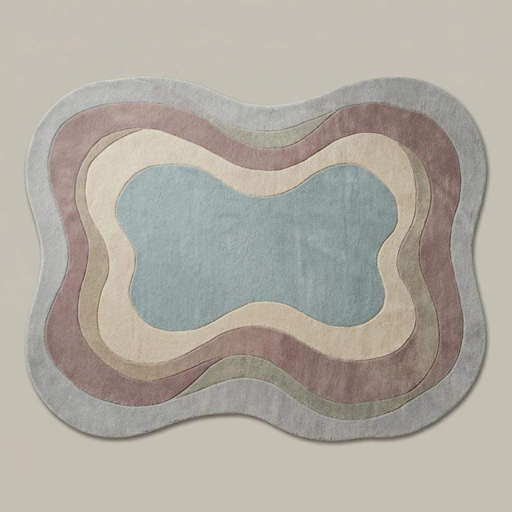 Translation missing: en.Abstract sculptural wool rug with curved edges and muted colors on wood flooring, handmade tufted carpet for contemporary decor