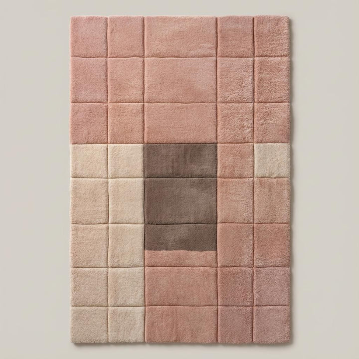 Translation missing: en.Top-down view of a modern geometric area rug in blush pink, cream, and taupe tones with a plush tufted texture beside a mustard chair and wood furniture