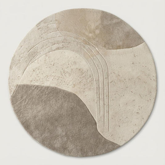Translation missing: es.Hand-tufted circular wool rug featuring carved textured patterns on light wood flooring in a modern Scandinavian interior