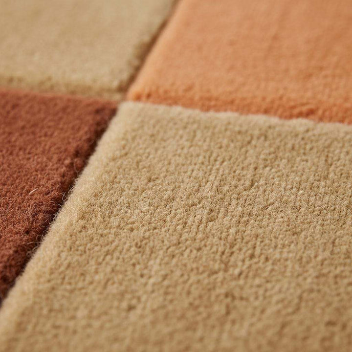 Translation missing: es.Mid century rug with geometric color block design in warm ochres and rust tones for modern living room