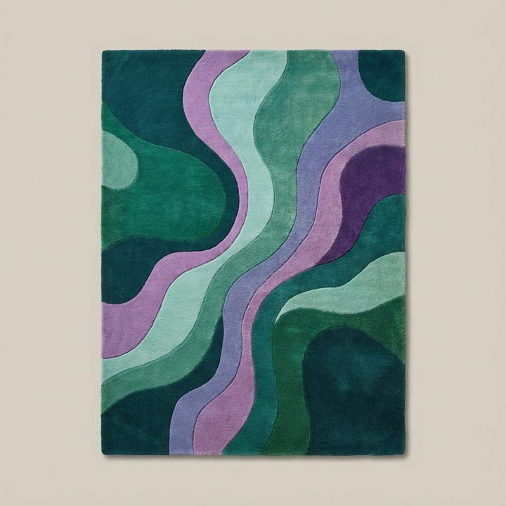Translation missing: en.Retro abstract wave pattern rug featuring bold greens and purples placed on parquet flooring near a modern teal armchair