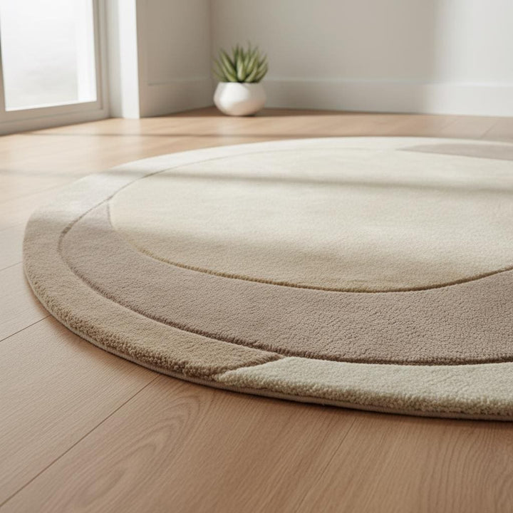 Translation missing: en.Contemporary organic-shape area rug with layered beige tones under minimalist armchairs