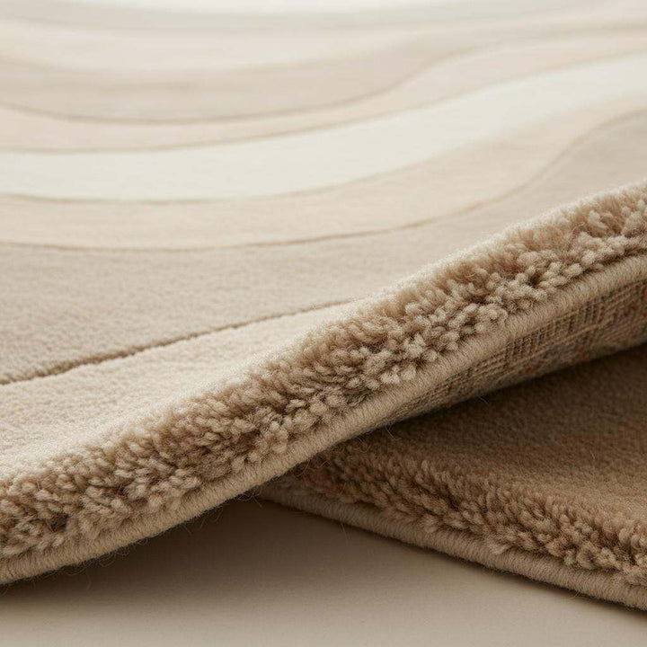 Translation missing: en.Beige cream area rug with wavy pattern in minimalist living room setting