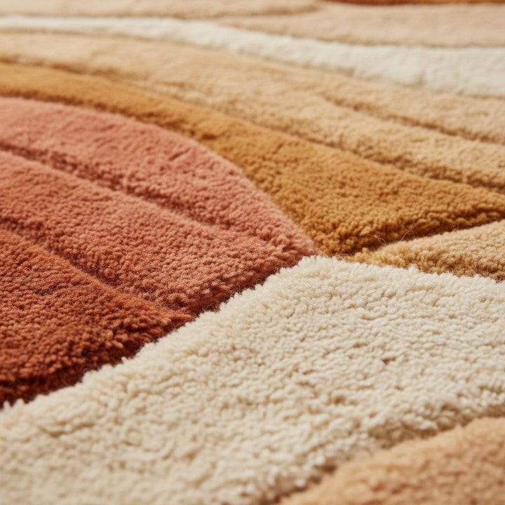 Translation missing: en.Mid century modern rug with sculpted wave design and earth tone colors in cozy living room setting
