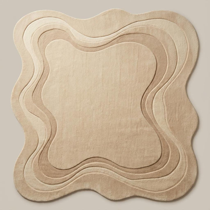Translation missing: en.Modern abstract rug in warm beige tone featuring soft organic silhouette and plush textured surface