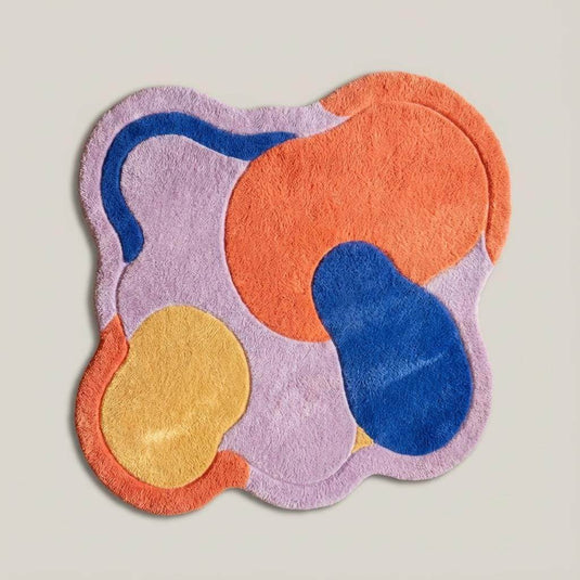Translation missing: es.Artistic modern rug featuring terracotta, blue, lavender, and mustard tones on hardwood floor