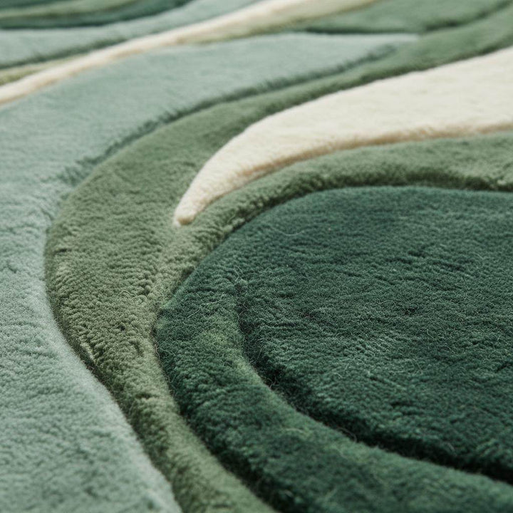 Translation missing: en.Close-up of sculpted abstract green rug showing plush tufted fibers, high-low texture, and curved organic pattern craftsmanship