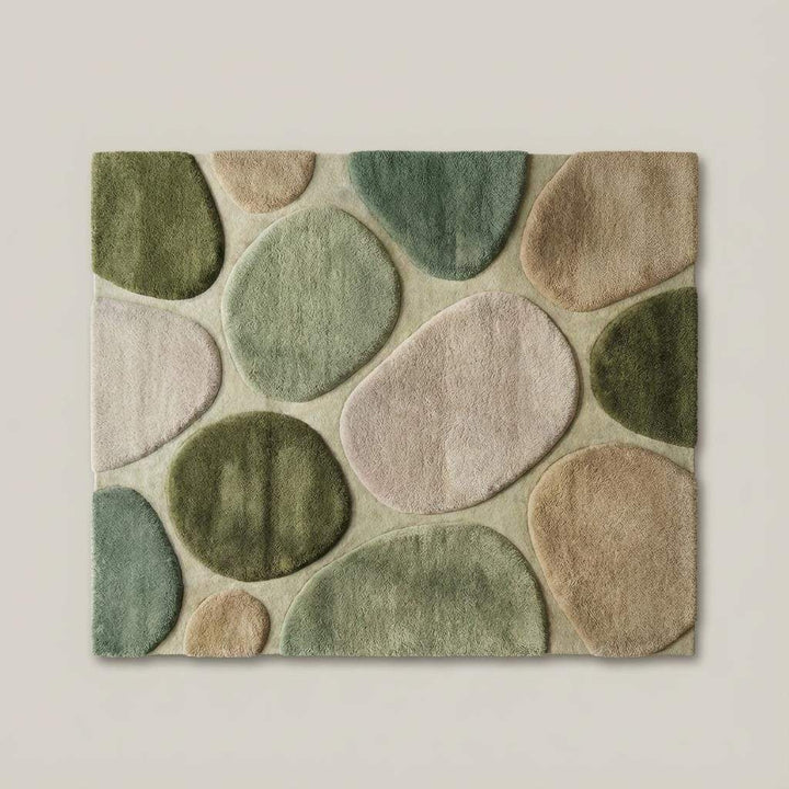 Translation missing: es.Top-down flat lay of organic modern area rug displaying abstract pebble pattern, curved shapes, and harmonious green and neutral color palette